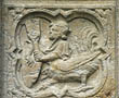 Panel 04:03 - Cockeral-bodied man carrying a shield and a shovel